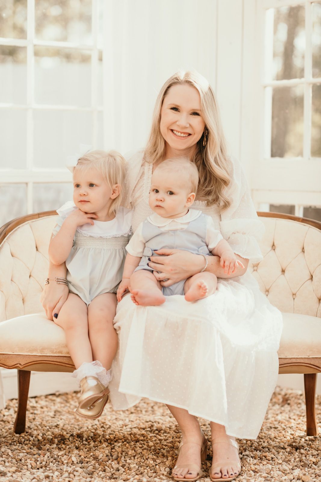 Beautiful family portrait on vintage sofa in soft, natural lighting.