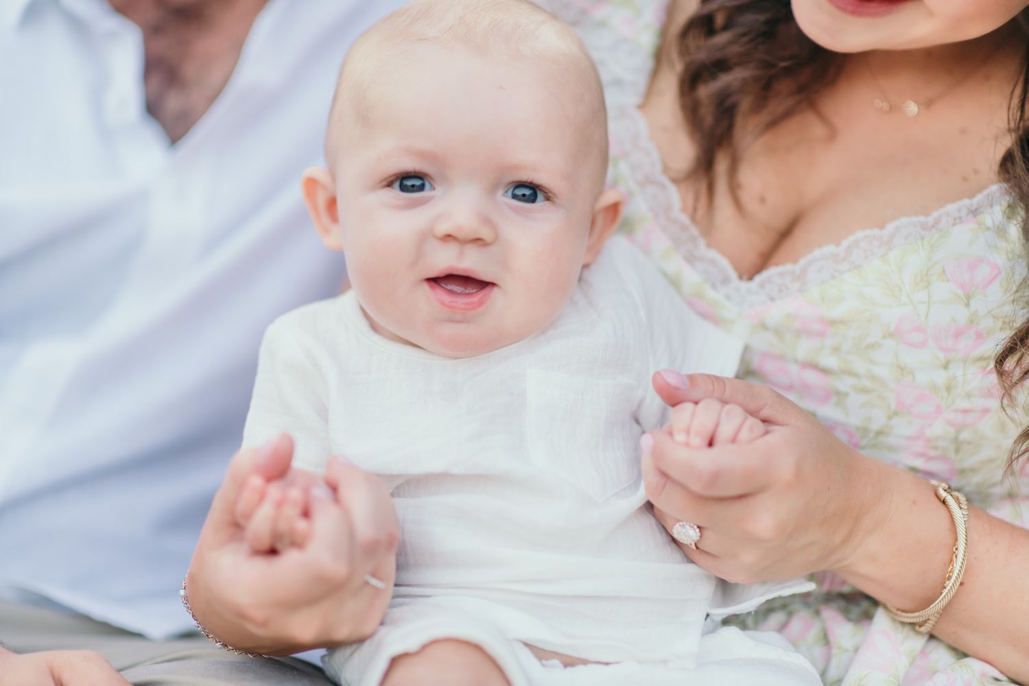 Close-up family portrait captures sweet interactions and smiles.