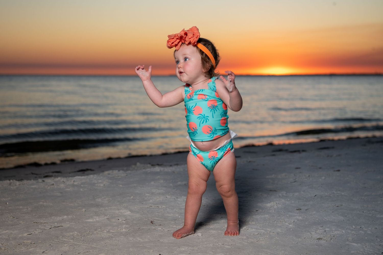 Beachside photo series during a vibrant orange sunset.