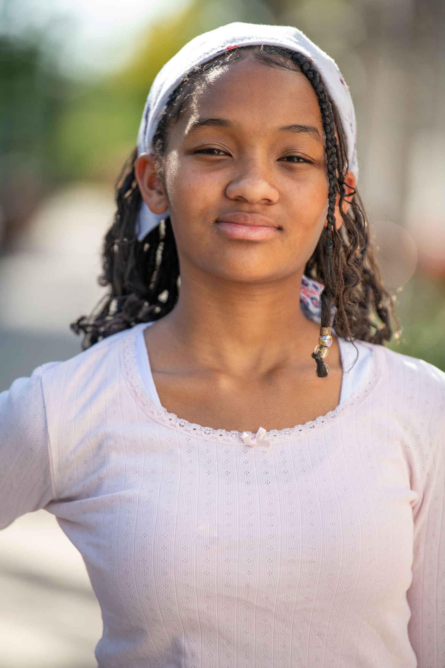 Casual outdoor portrait session with soft natural lighting and greenery. Headshots.