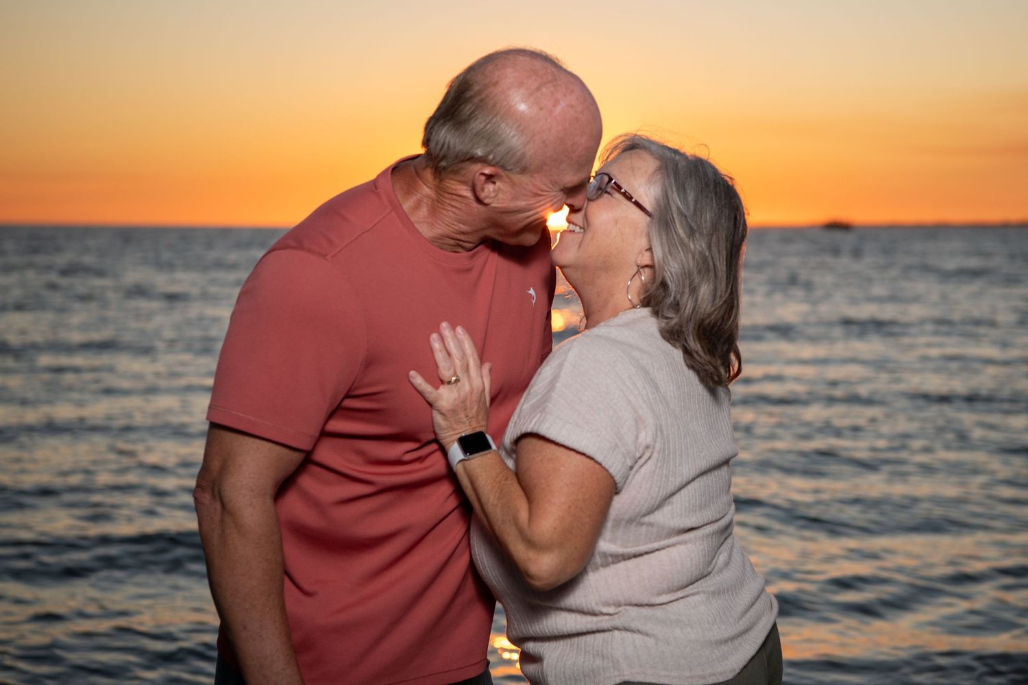 Couple sharing intimate moment at beach during sunset. Couples photoshoot.
