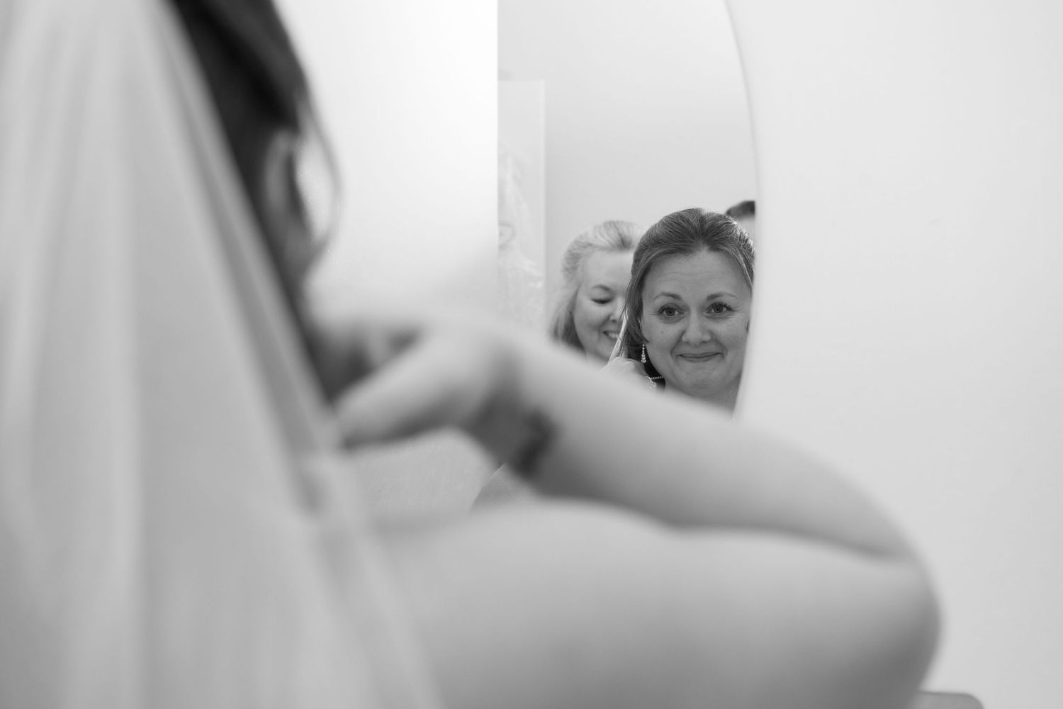 Artistic black and white shots of wedding dress preparations.