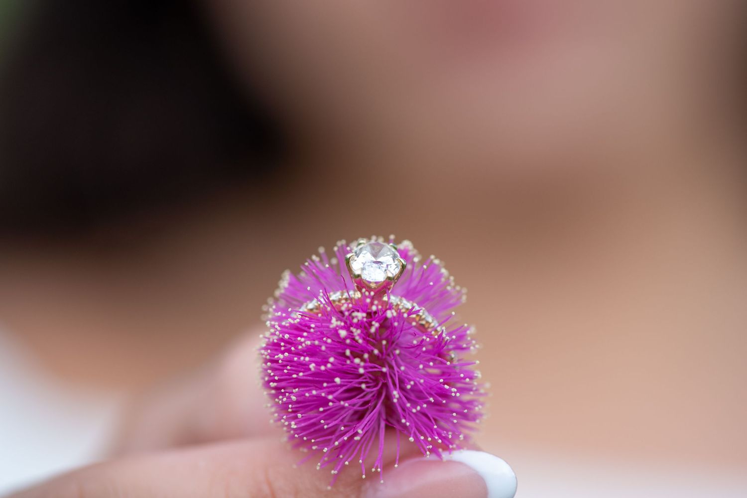 Pink floral decorations arranged in a row against a blurred background.