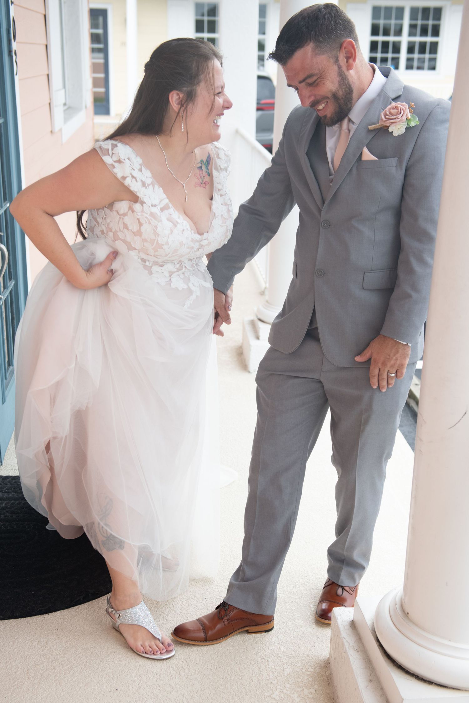 A couple shares an intimate moment in formal wedding attire with the bride wearing a white lace dress.