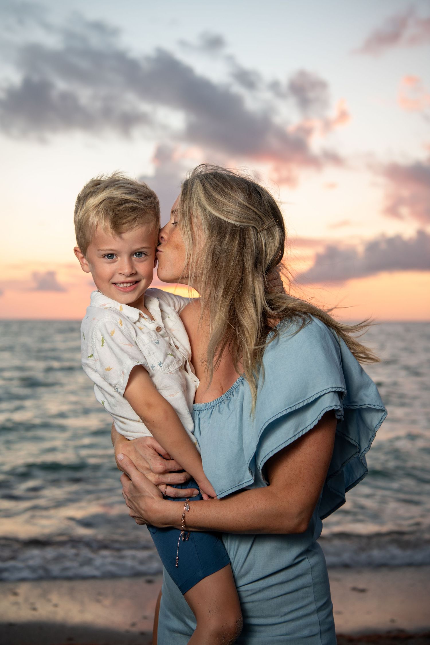 Sweet candid moments between family members on a beach at golden hour. Beach photoshoot. Family photoshoot,
