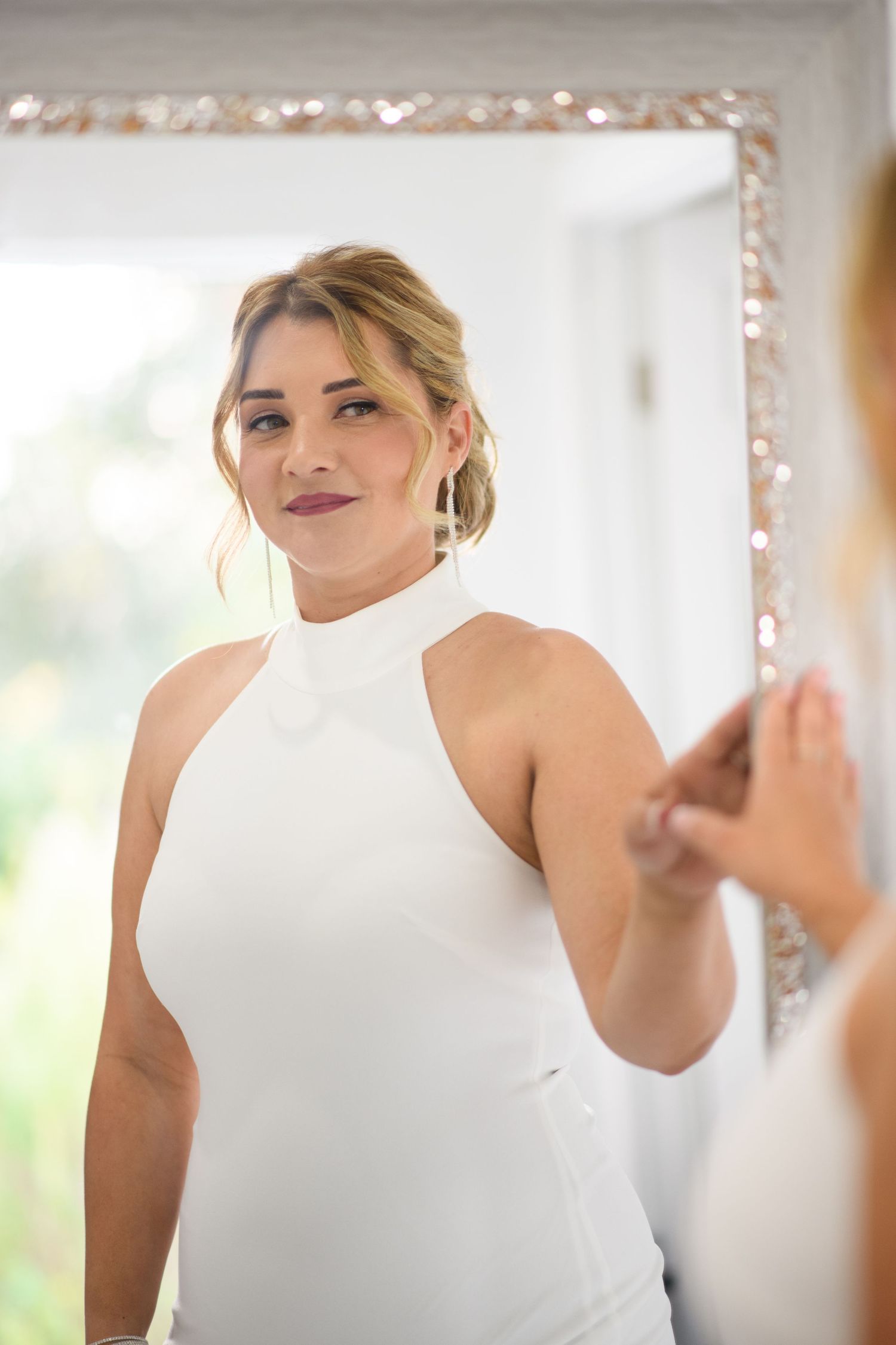 wedding portraits of bride in elegant white halter wedding dress.