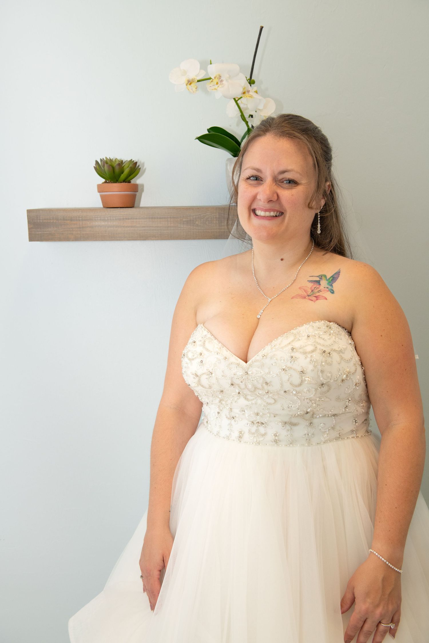 Beautiful strapless wedding gown with beaded bodice and flowing skirt.