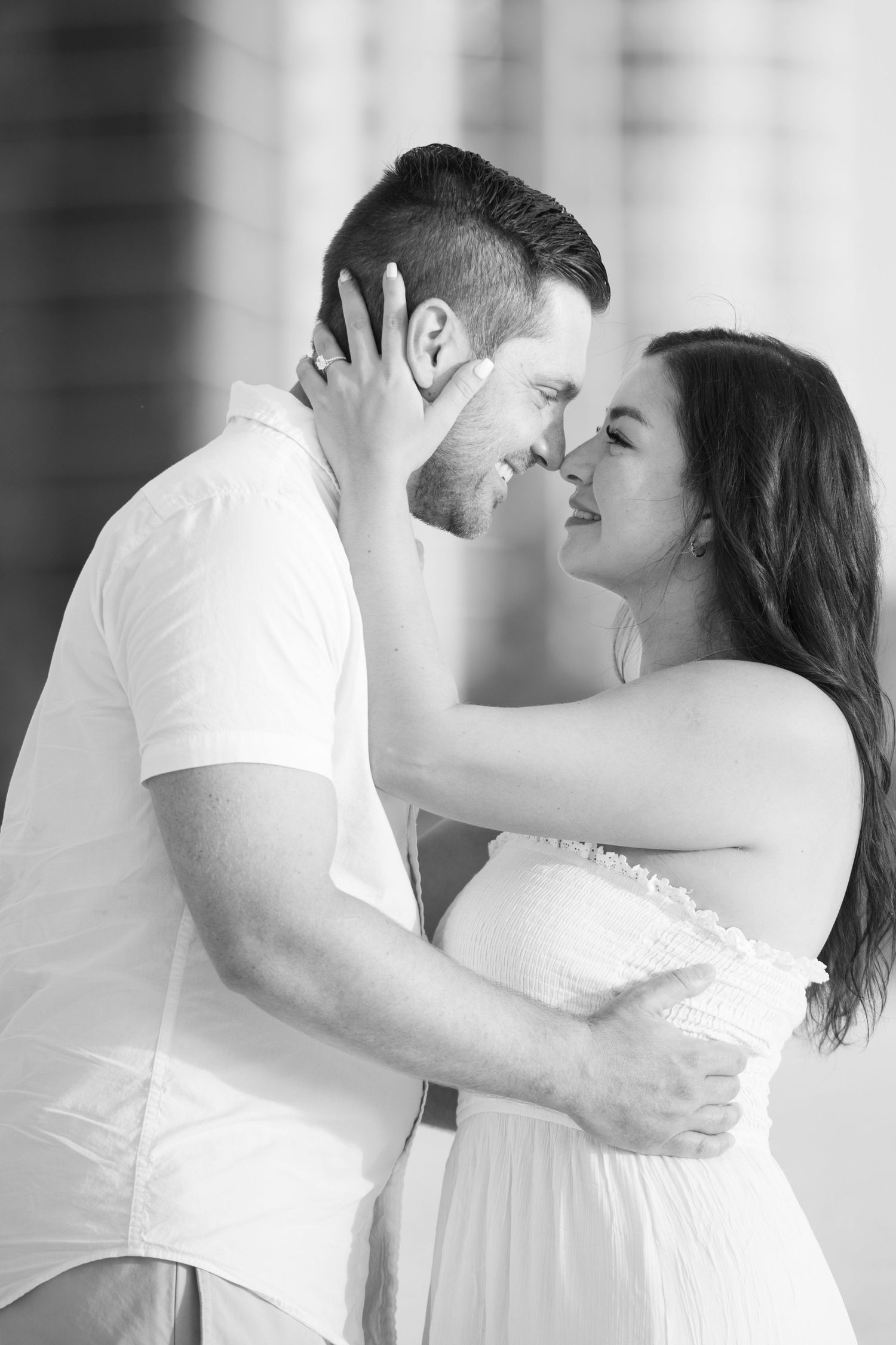 Black and white indoor portrait session capturing tender moments and laughter.