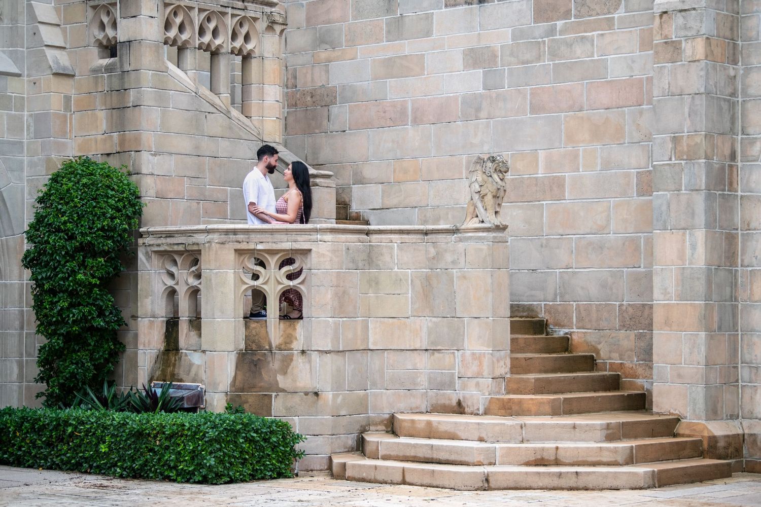 Stone steps and architectural details frame a romantic moment at a historic location.