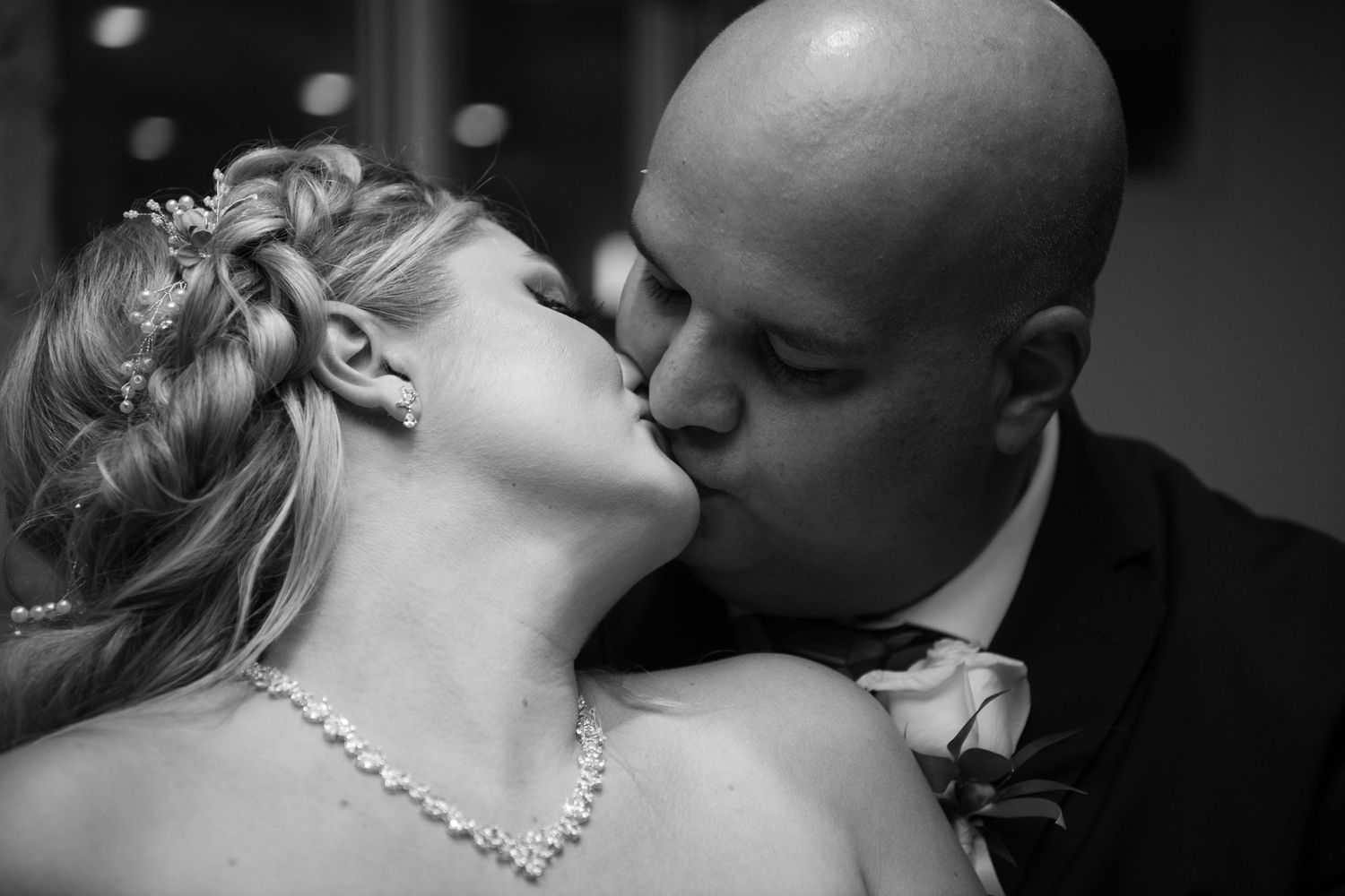 Black and white wedding photo series showing intimate moments between newlyweds.