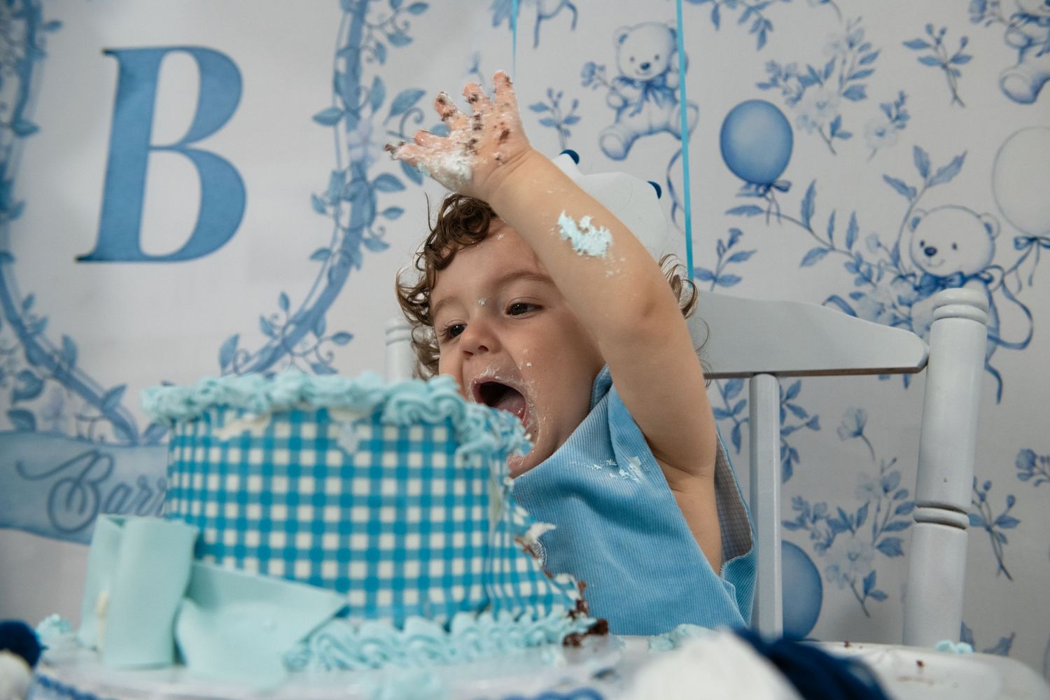 A blue and white themed birthday party setup with decorative banners and cake.