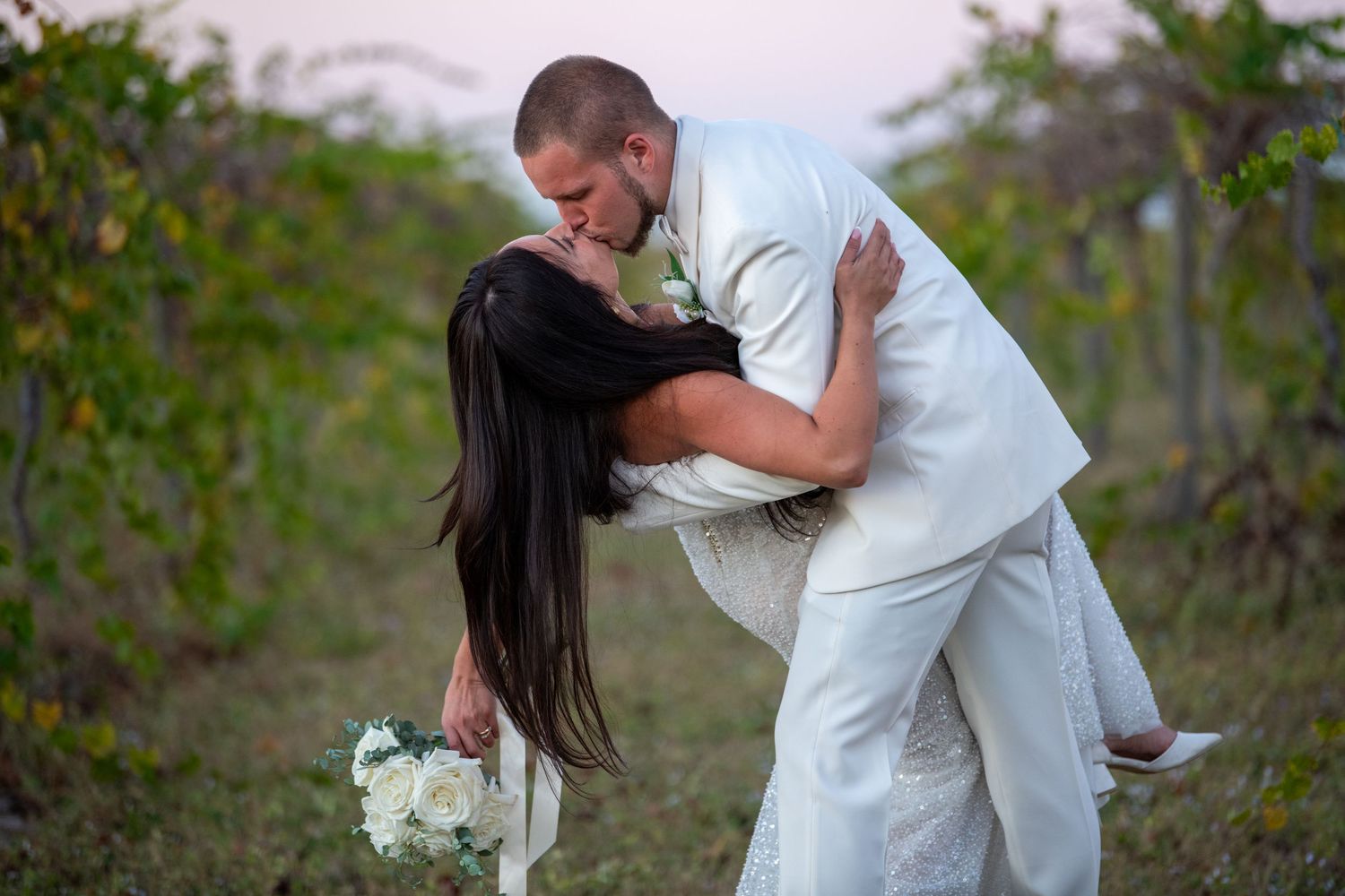 Romantic outdoor wedding photos with couple embracing in a natural setting. Wedding photography.