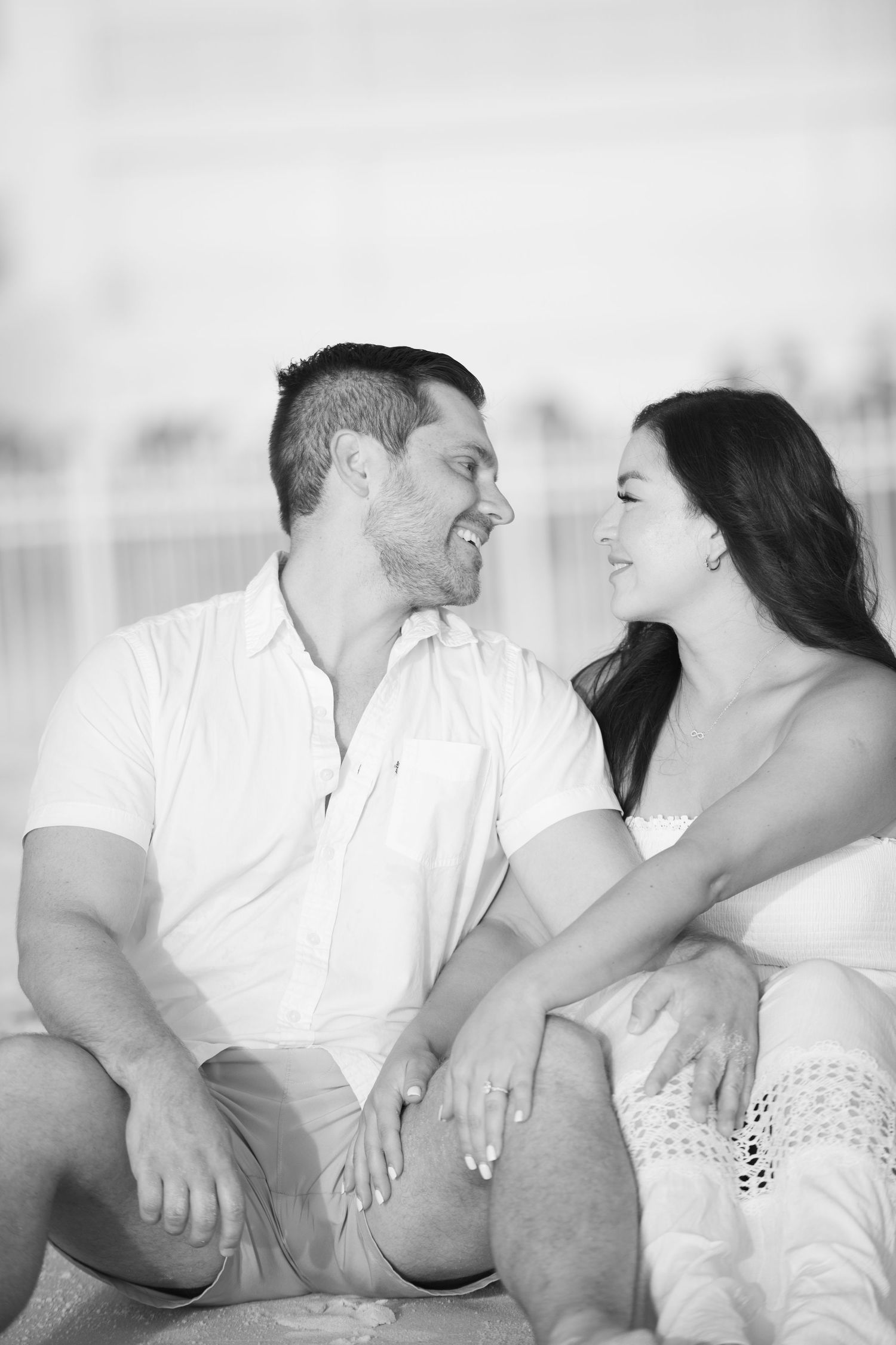 Black and white intimate photo session showing joyful laughter and connection.