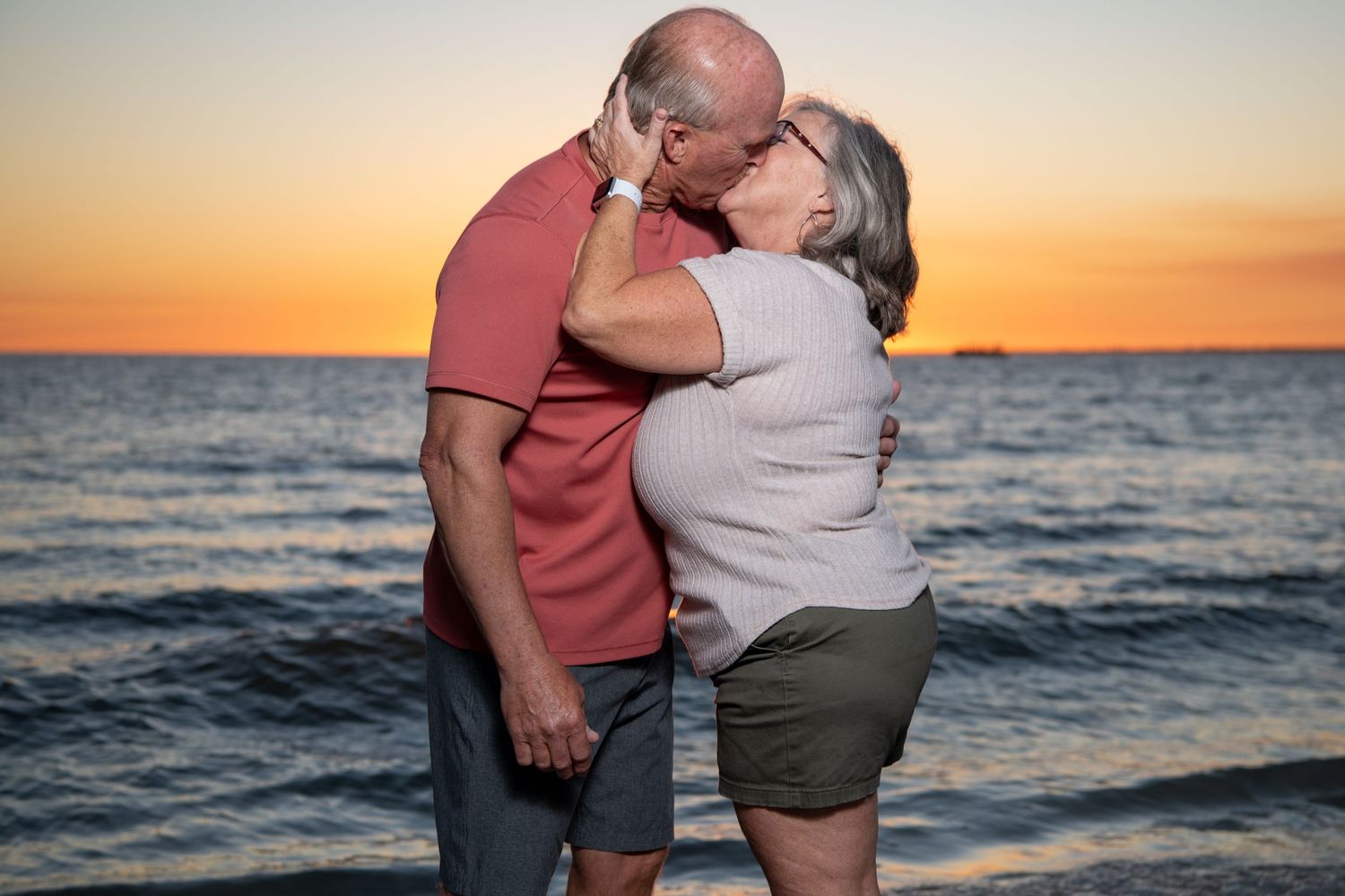 Romantic sunset beach portrait of couple embracing. Couples photoshoot.