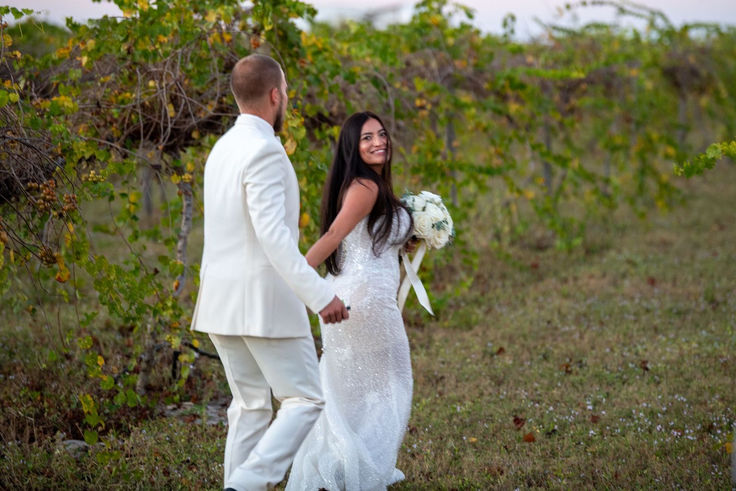 Romantic wedding moments photographed against a natural outdoor backdrop. Wedding photography.