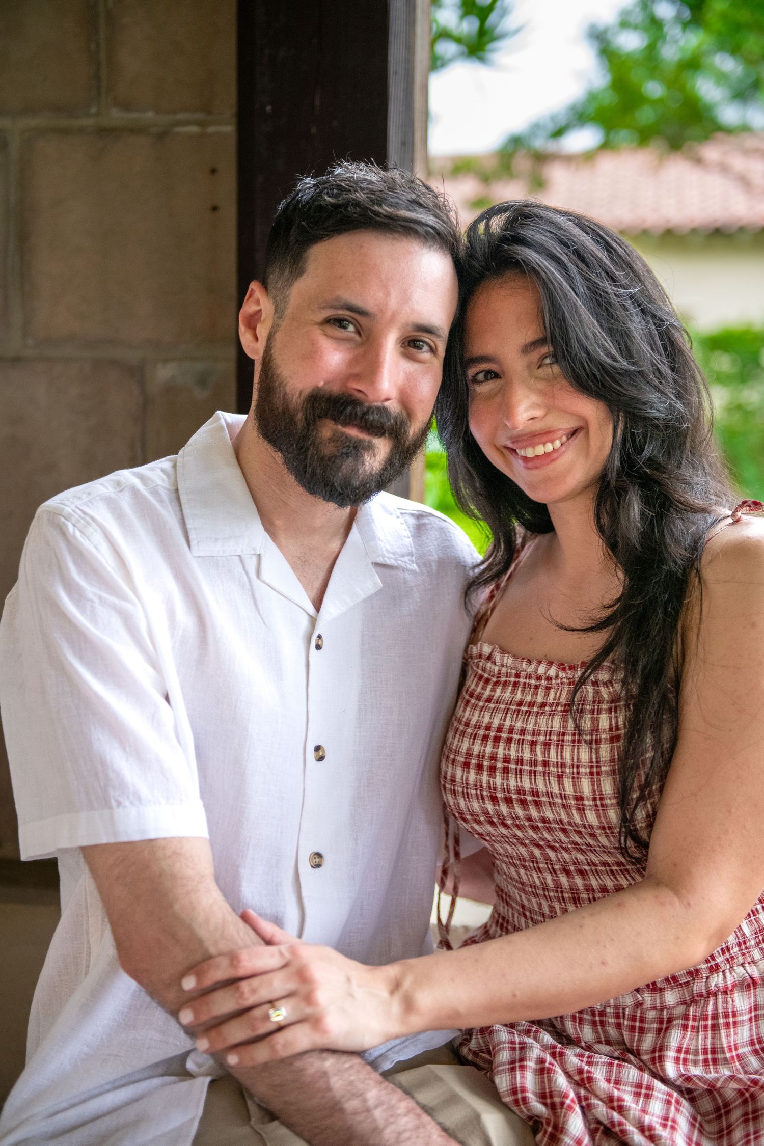 A romantic photoshoot under gothic stone arches with natural lighting.