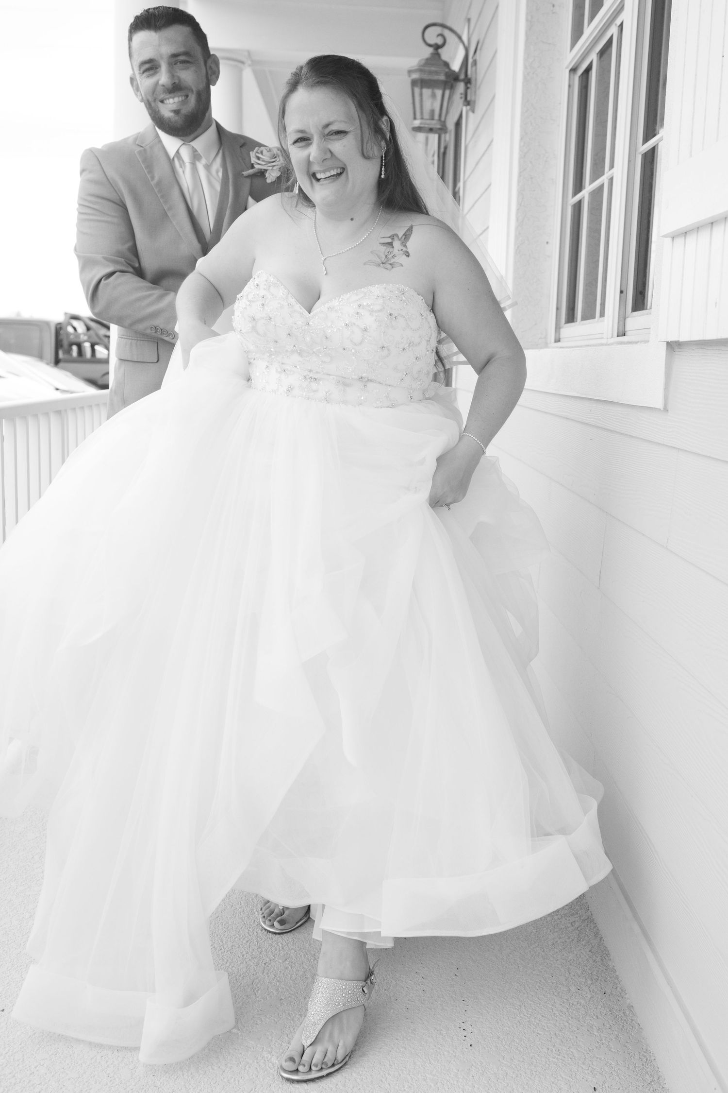 Light and airy wedding portraits on a white porch.