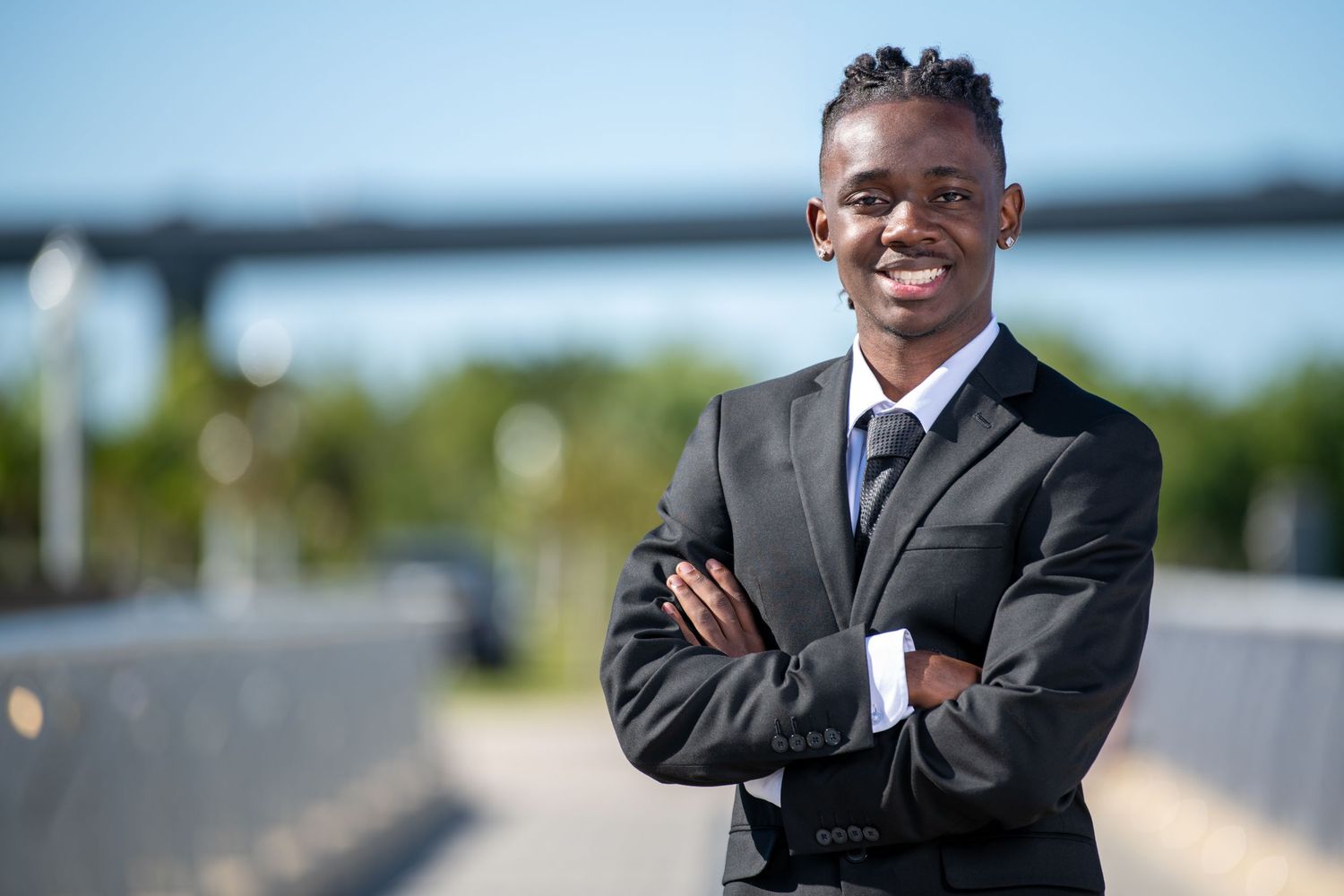 A series of outdoor business portraits showing a person in formal attire smiling at the camera. Professional headshots. Self portraits.