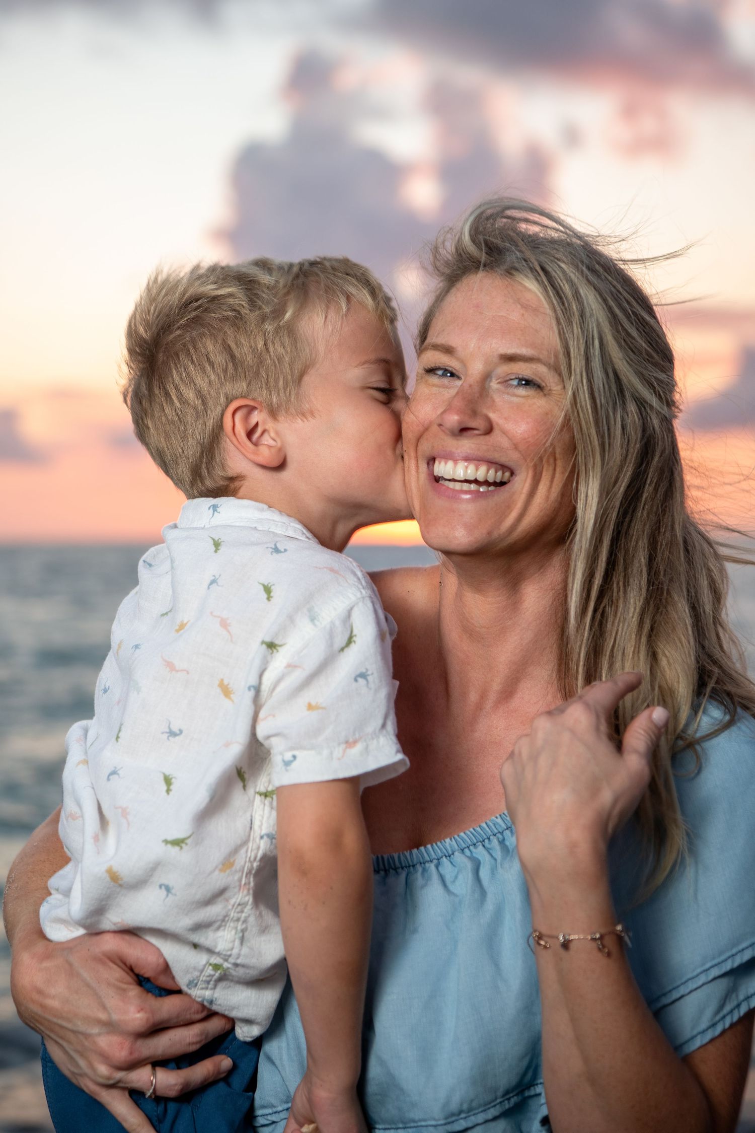 Tender family moments captured against a stunning beach sunset backdrop. Beach photoshoot. Family photoshoot,