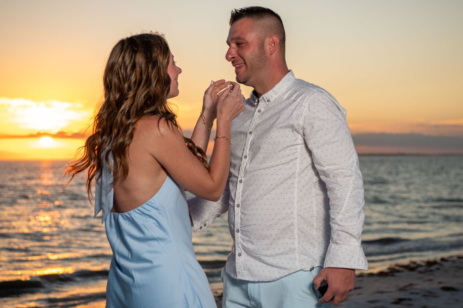 Sunset beach photography session with couple in casual attire. Engagement photoshoot. Couples photos.