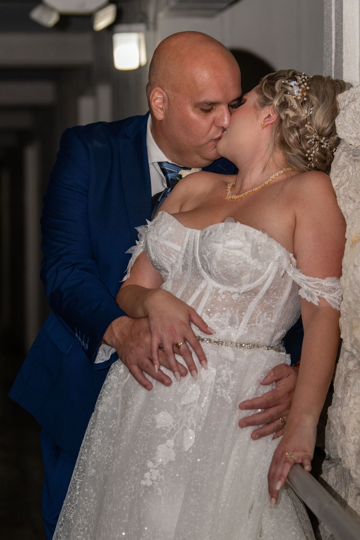 Romantic sequence of newlyweds embracing in white dress and navy suit.
