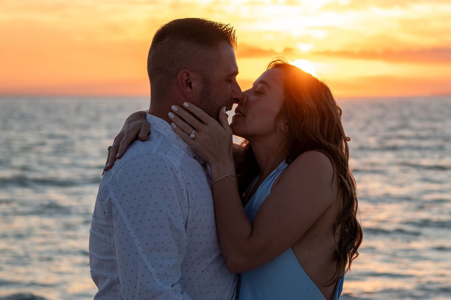 Golden hour beach engagement photos with dramatic sunset over ocean. Engagement photoshoot. Couples photos.