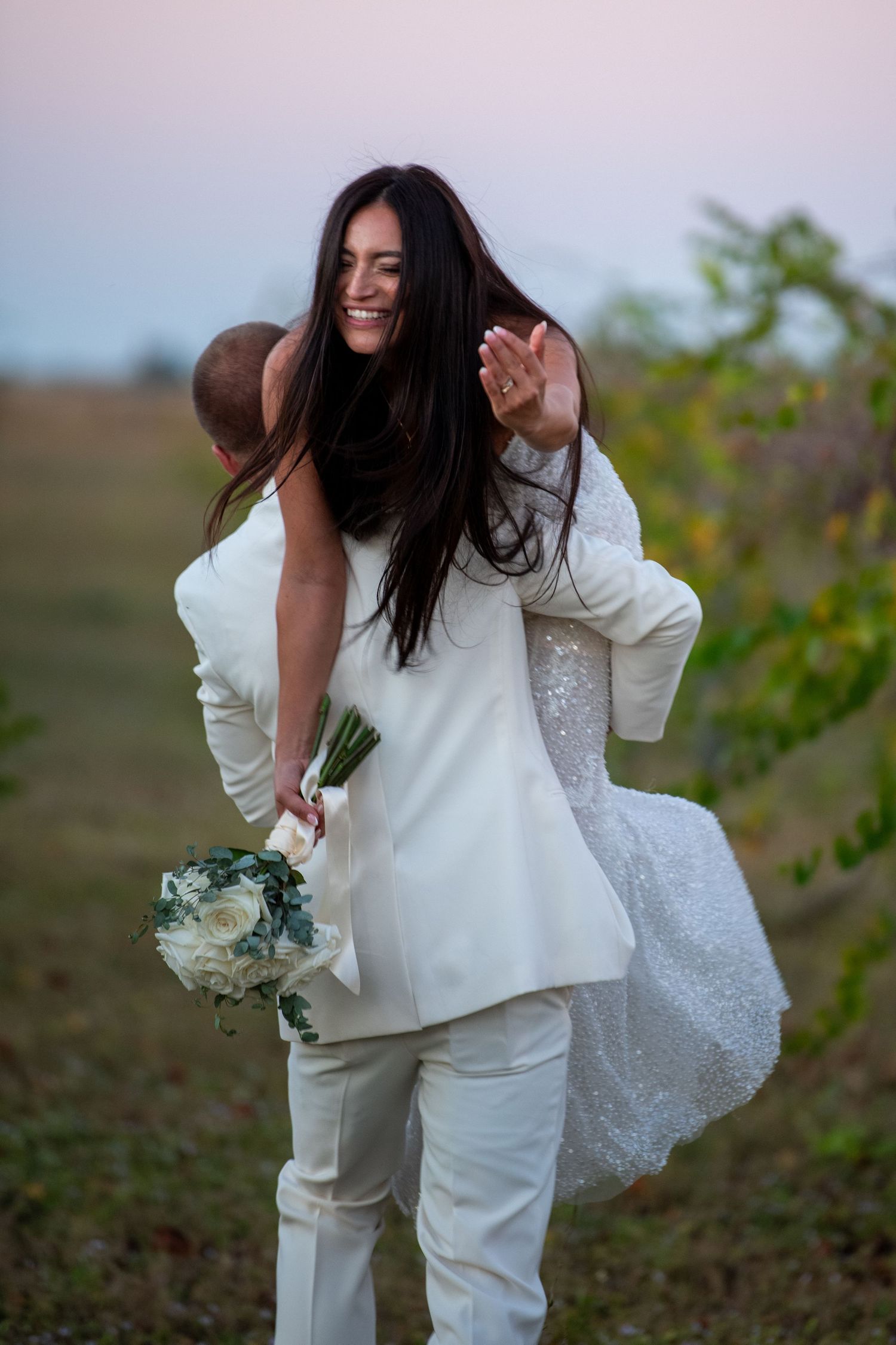 Playful wedding photos captured in a rustic outdoor setting with natural lighting. Wedding photography.