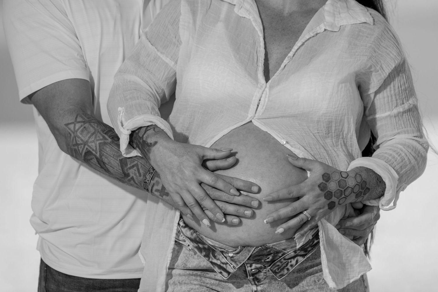 Black and white series of intimate couple portraits showing hands and embraces.