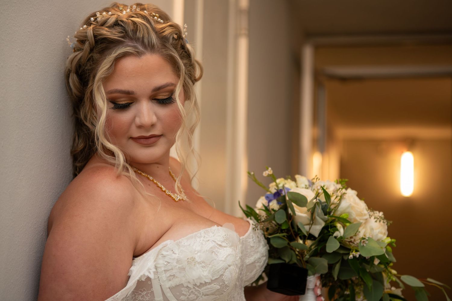 Elegant bridal portrait with upswept hairstyle and classic makeup.