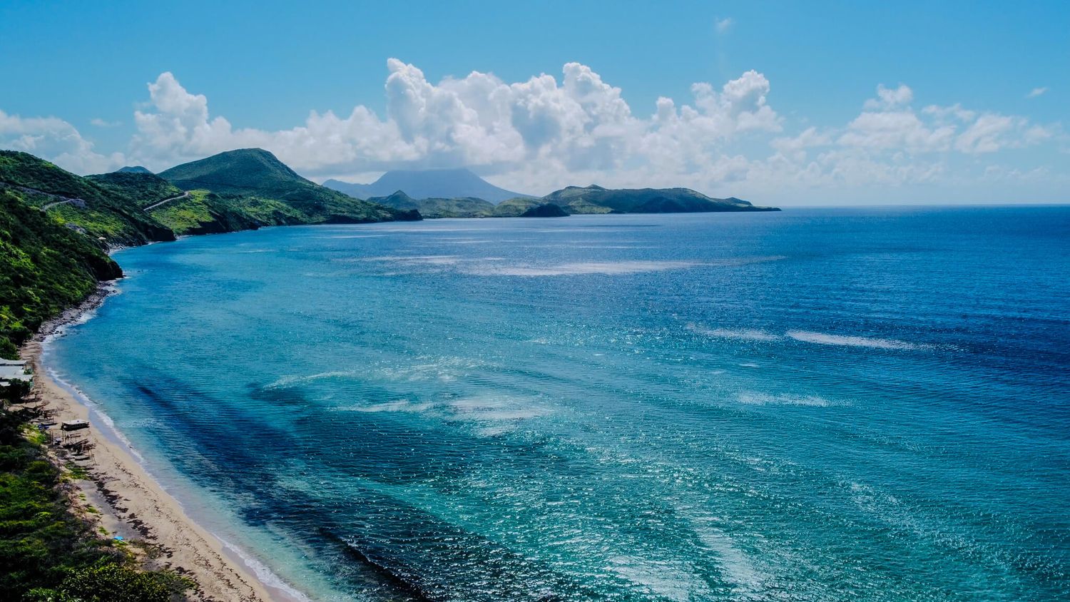 Aerial panoramic views of St. Kitts of turquoise ocean waters. Stop here on the best St. Kitts Tours with St. Kitts Cruise Photography.