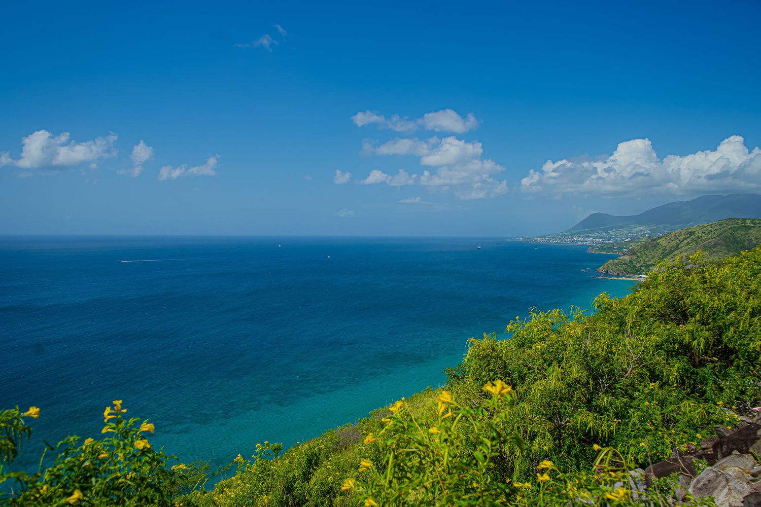 Panoramic coastal view of turquoise ocean waters of St. Kitts. Stop here on the best St. Kitts Tours with St. Kitts Cruise Photography.