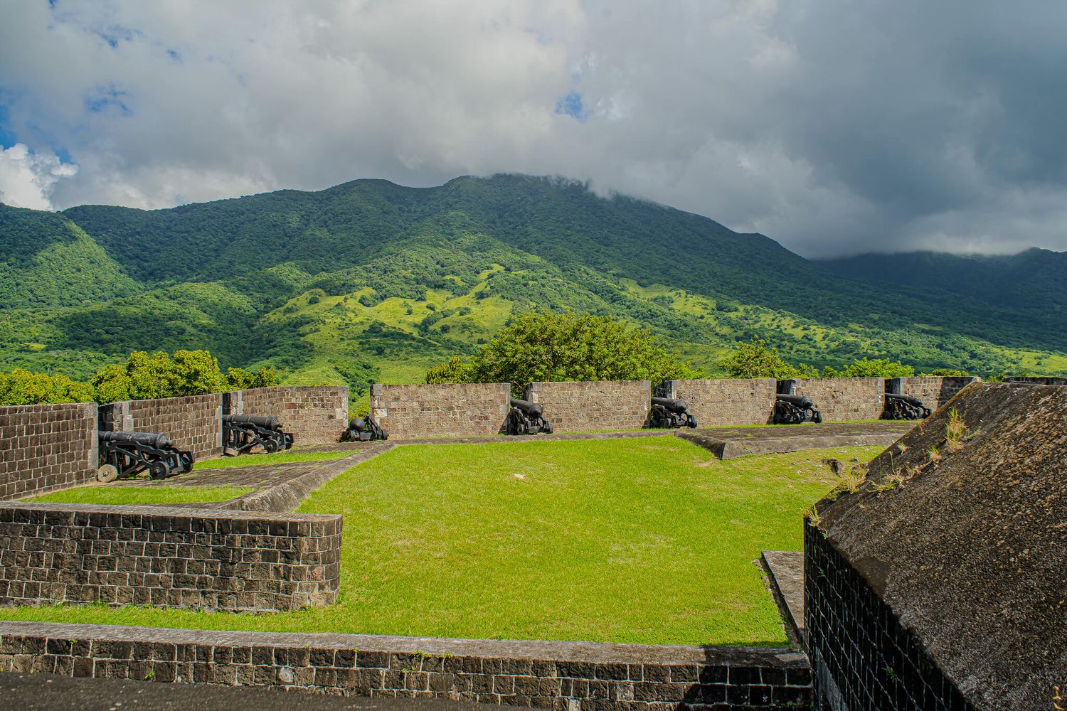 Historic stone fortress walls of Brimstone Hill in St. Kitts overlooking the Mount Liamuiga volcano.