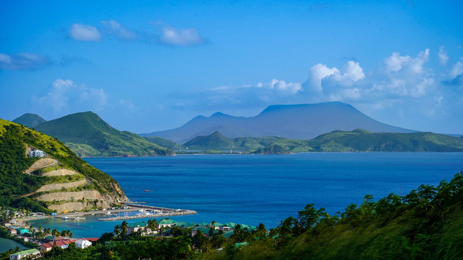 A beautiful picture from above Frigate Beach in St. Kitts with a view of the Nevis volcano. Stop here on the best St. Kitts Tours.