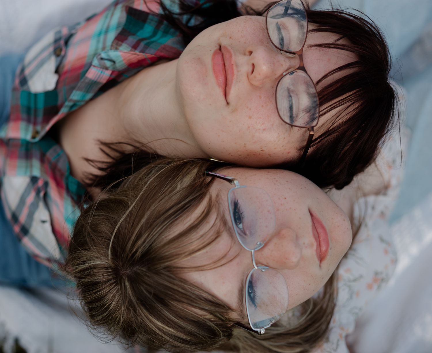 Close-up portrait shots of person wearing glasses against blue background.
