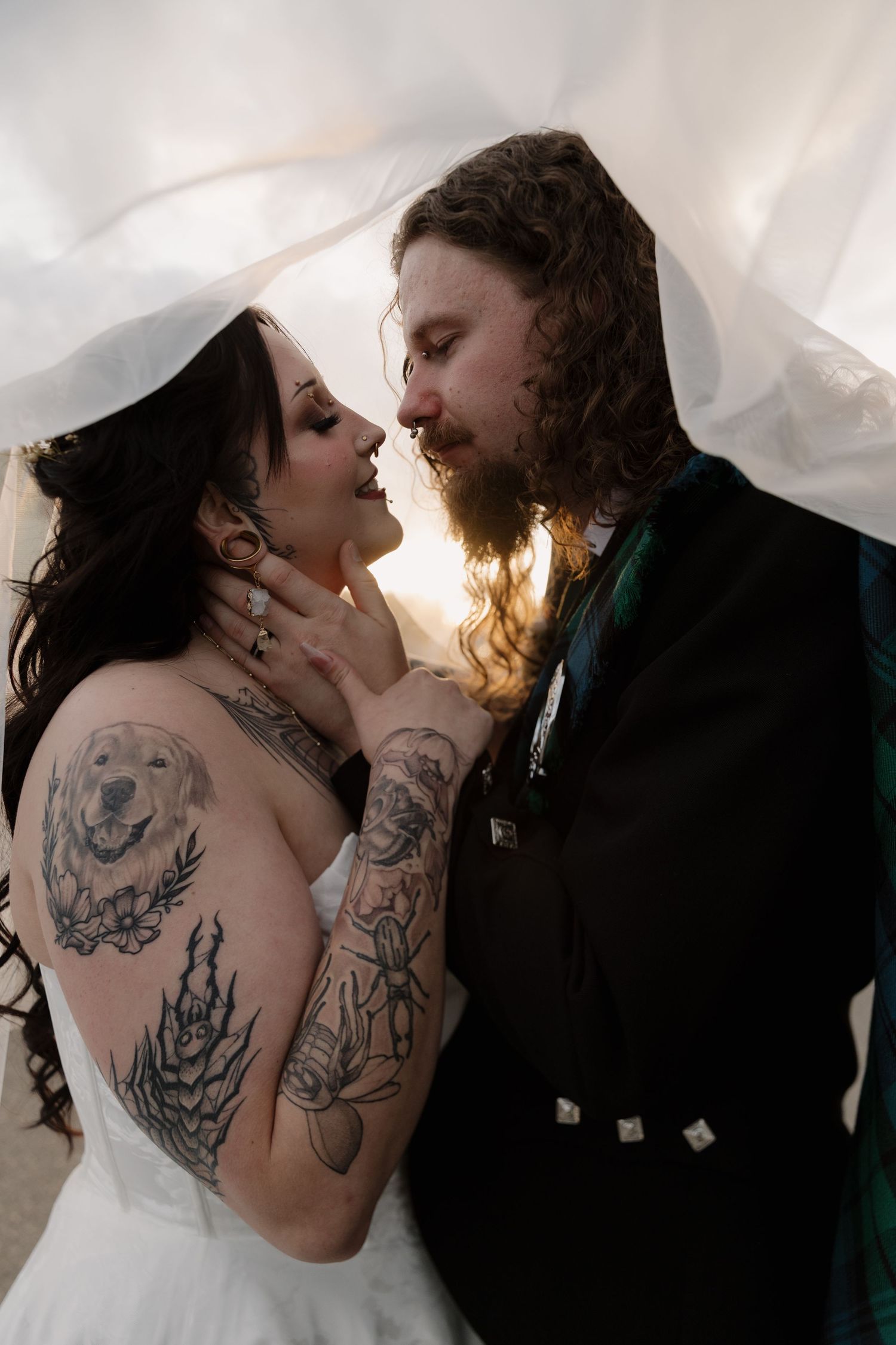 A romantic series of wedding photos showing a couple embracing and kissing with visible tattoos against a light background.