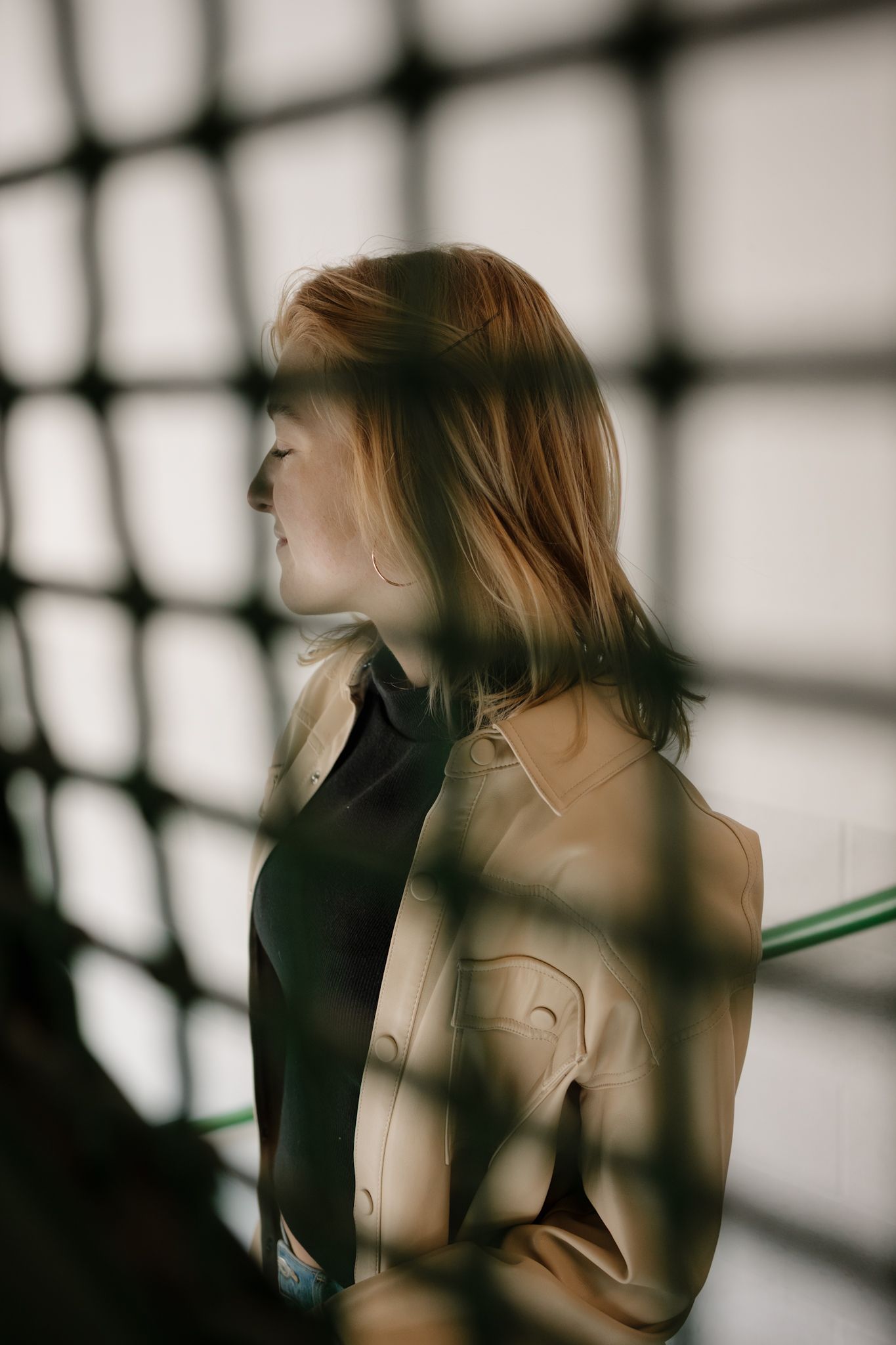 A series of moody artistic portraits showing a figure in motion against a window with dramatic lighting and shadows.