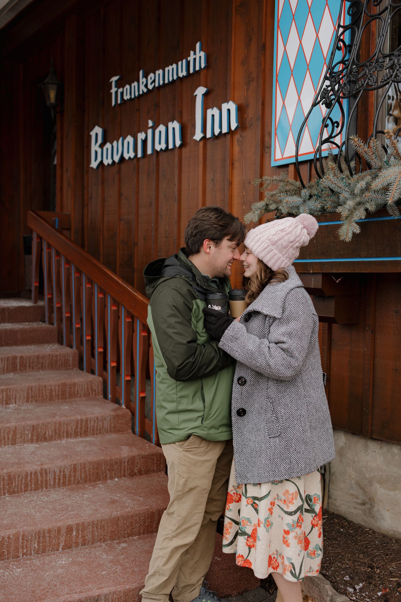 A couple shares a romantic moment outside the Frankenmuth Bavarian Inn in Michigan during winter.
