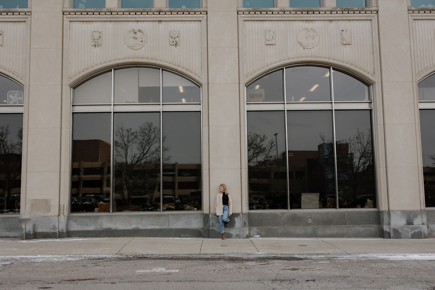 Commercial retail storefront with glass windows and concrete facade showing multiple empty retail spaces.