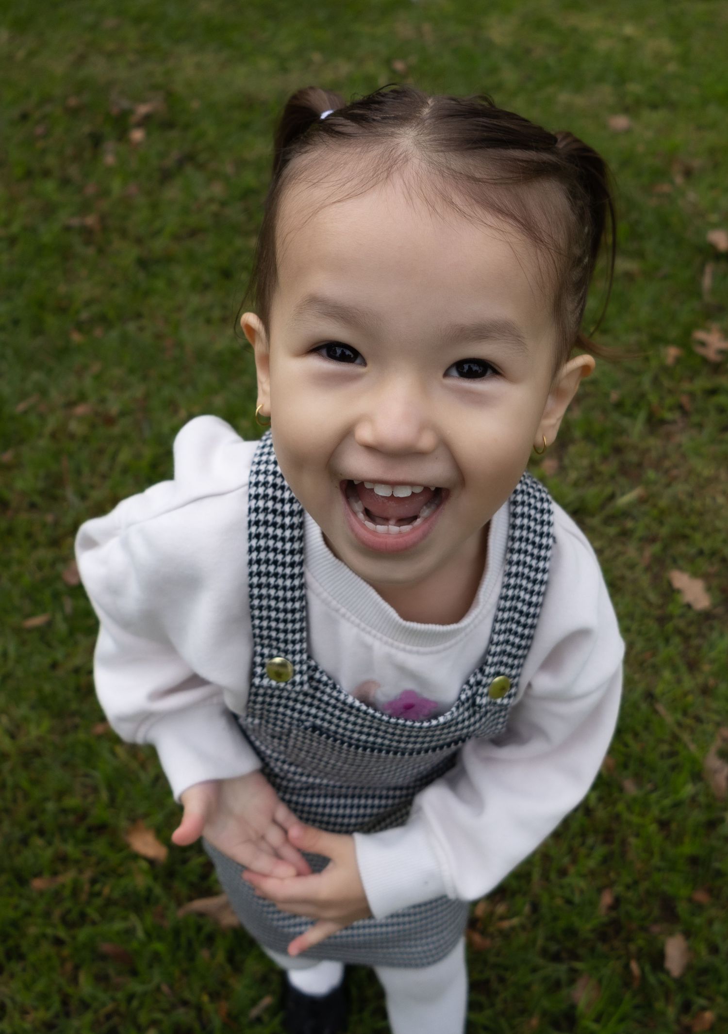 Little girl laughing while playing during a family session in Albury.