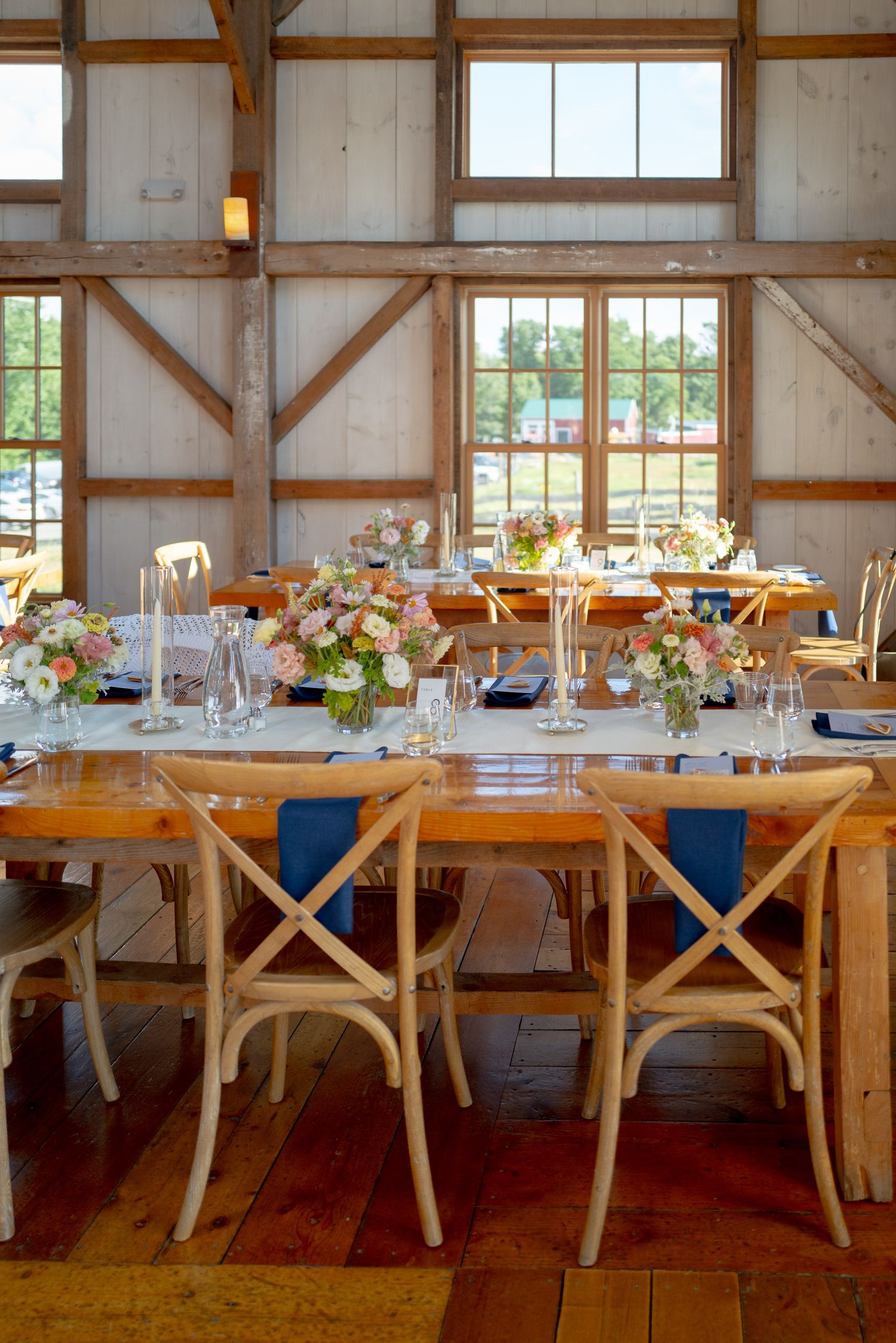 Black and white photo of bride and groom sharing first dance in a rustic barn wedding venue.