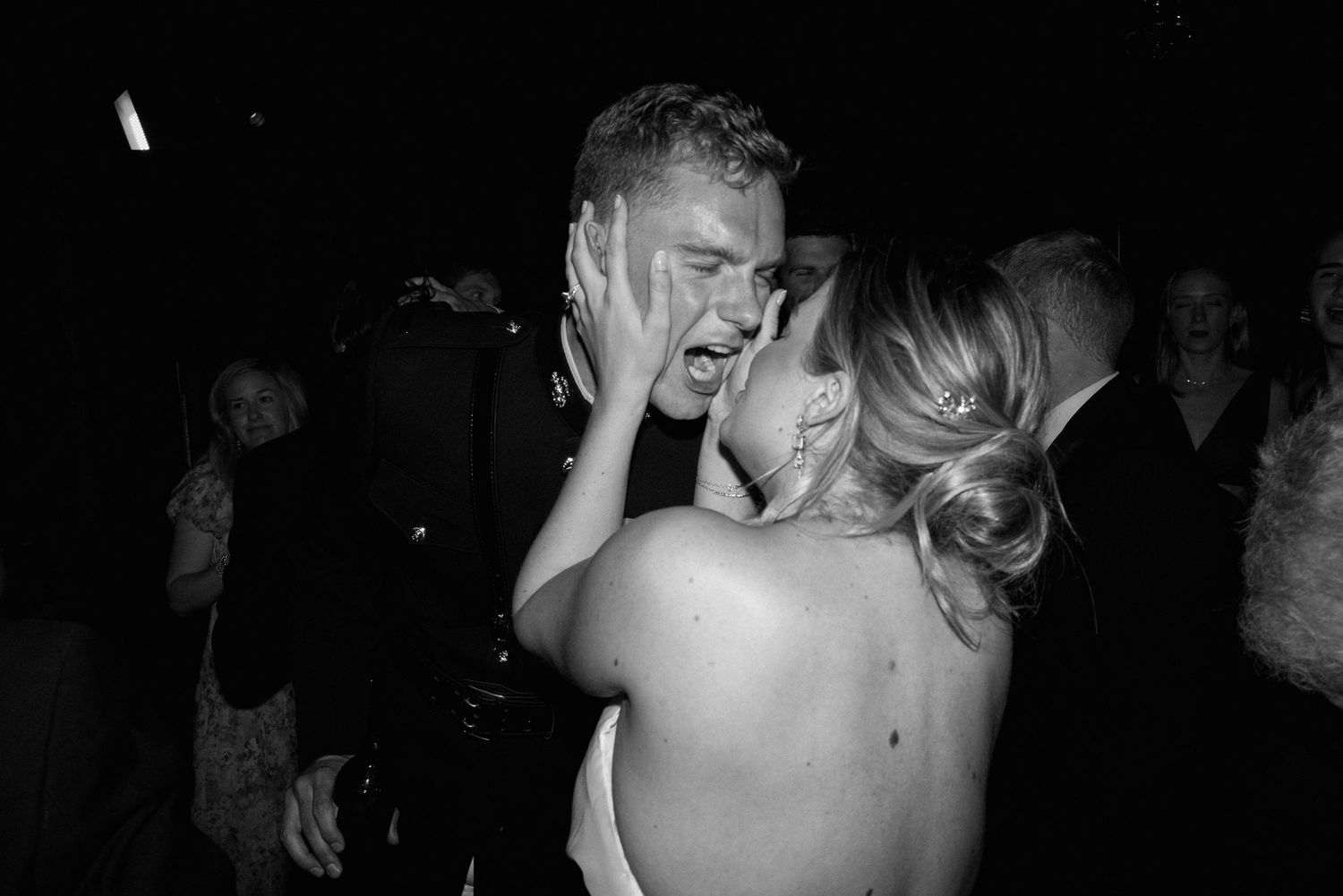 Black and white candid of bride and groom sharing an emotional intimate moment on the wedding dance floor.