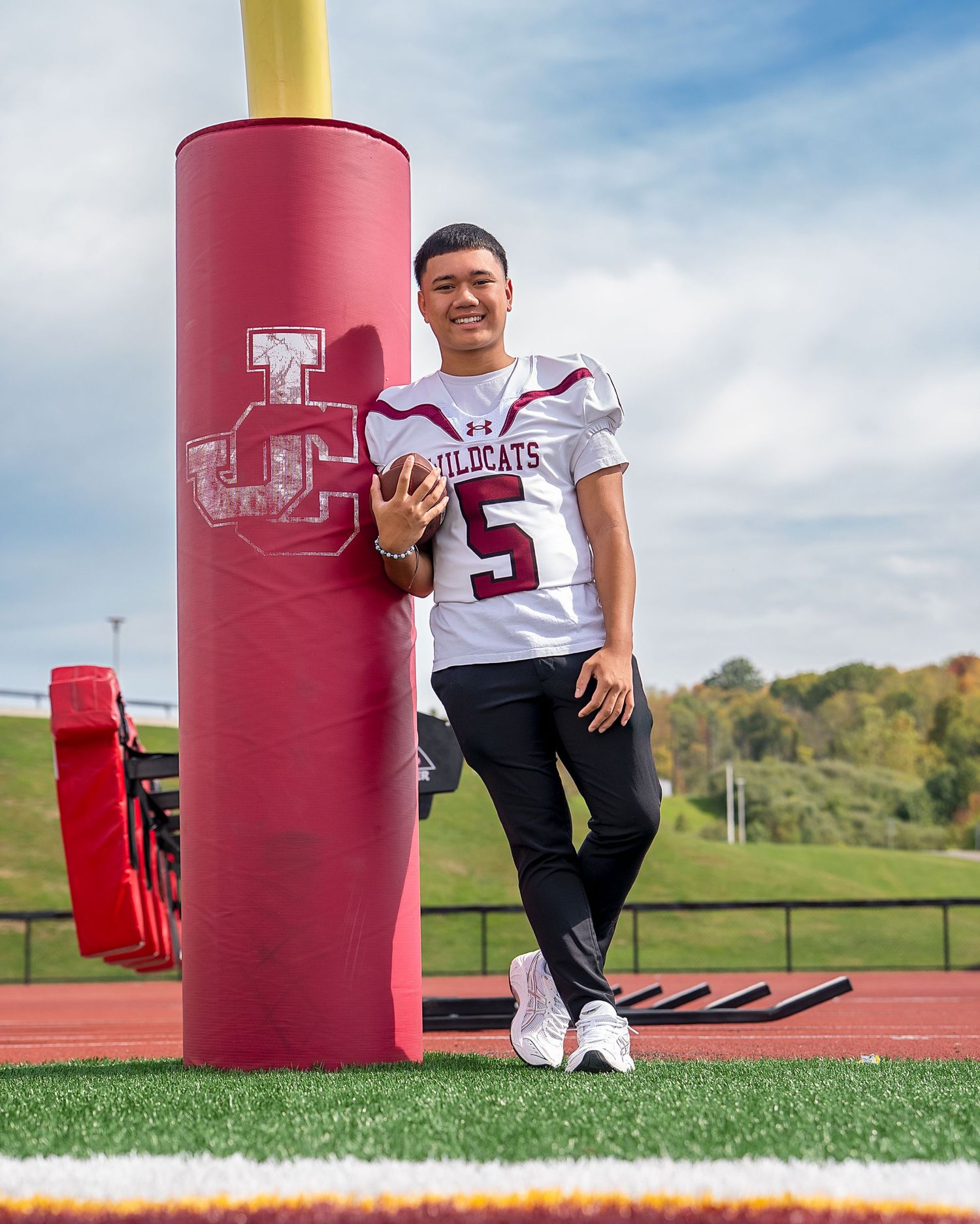 senior standing next to football goal post johnson city ny