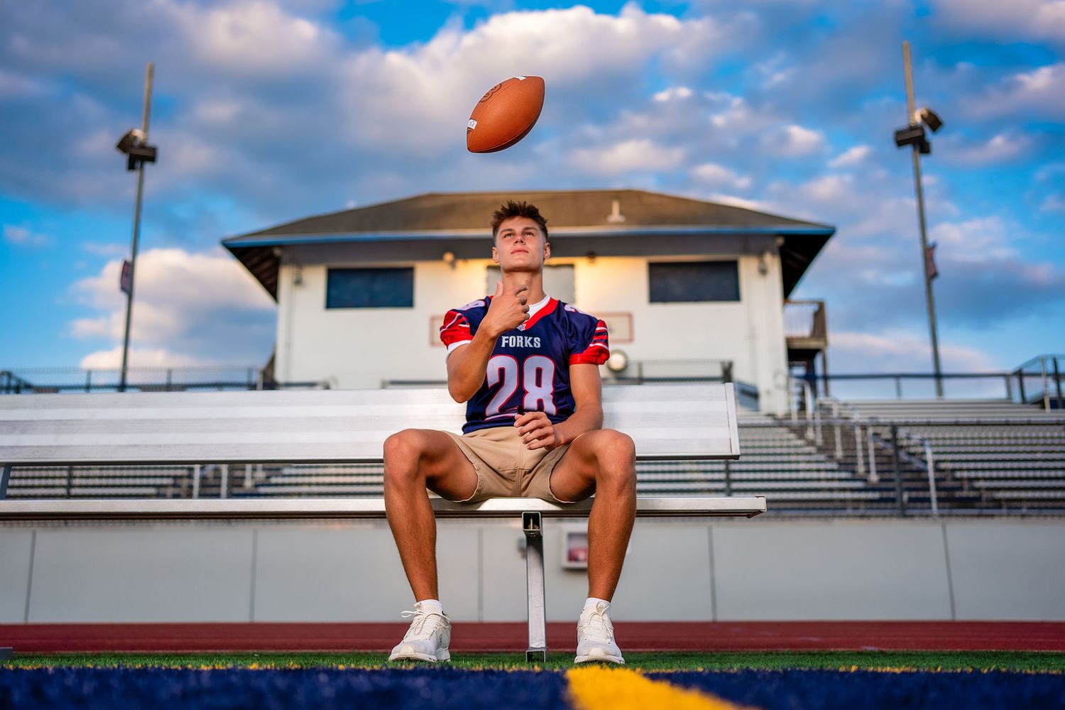 High school football senior portrait at sunset in Johnson City, NY featuring a Section IV athlete during a custom senior photography session