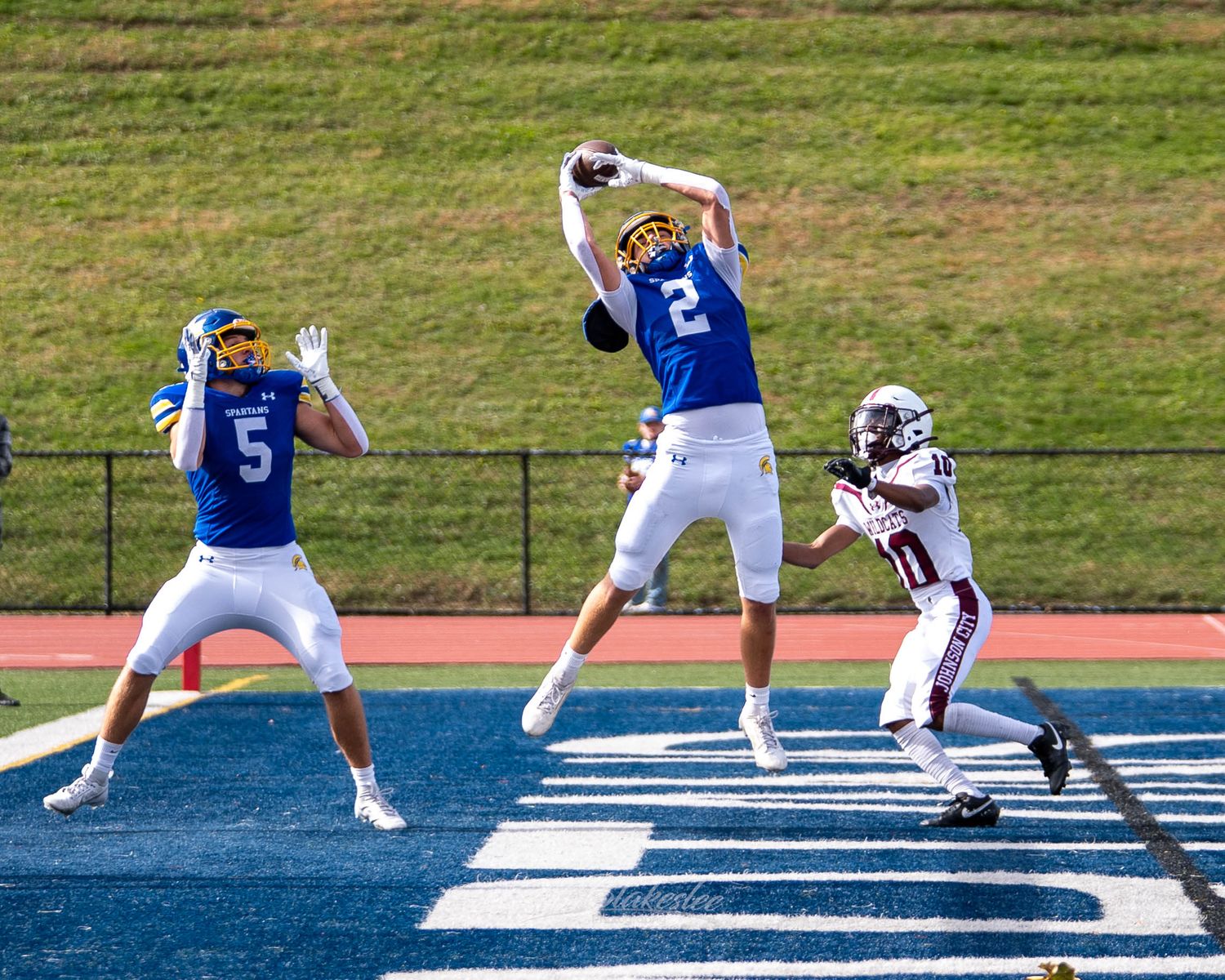 High school football receiver catches a touchdown pass during a varsity Section IV football game in Maine, NY.