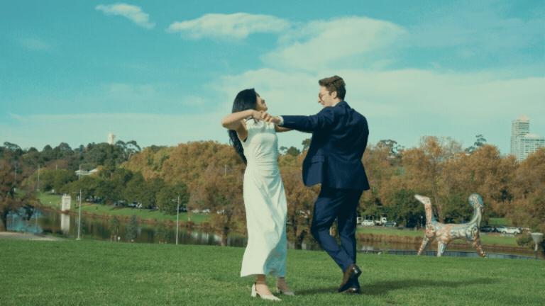 Couple dancing together on a hill.