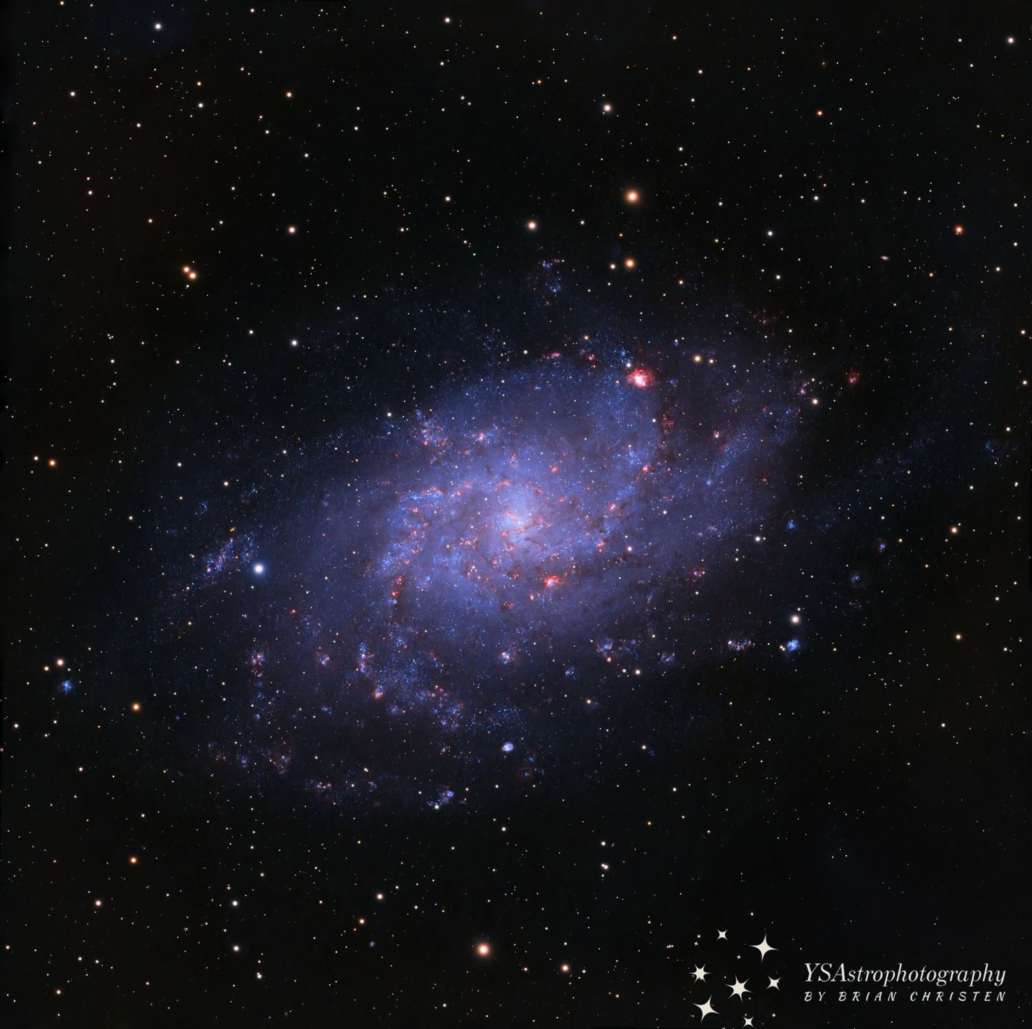 A stunning spiral galaxy with blue and purple hues, surrounded by stars in deep space astrophotography.