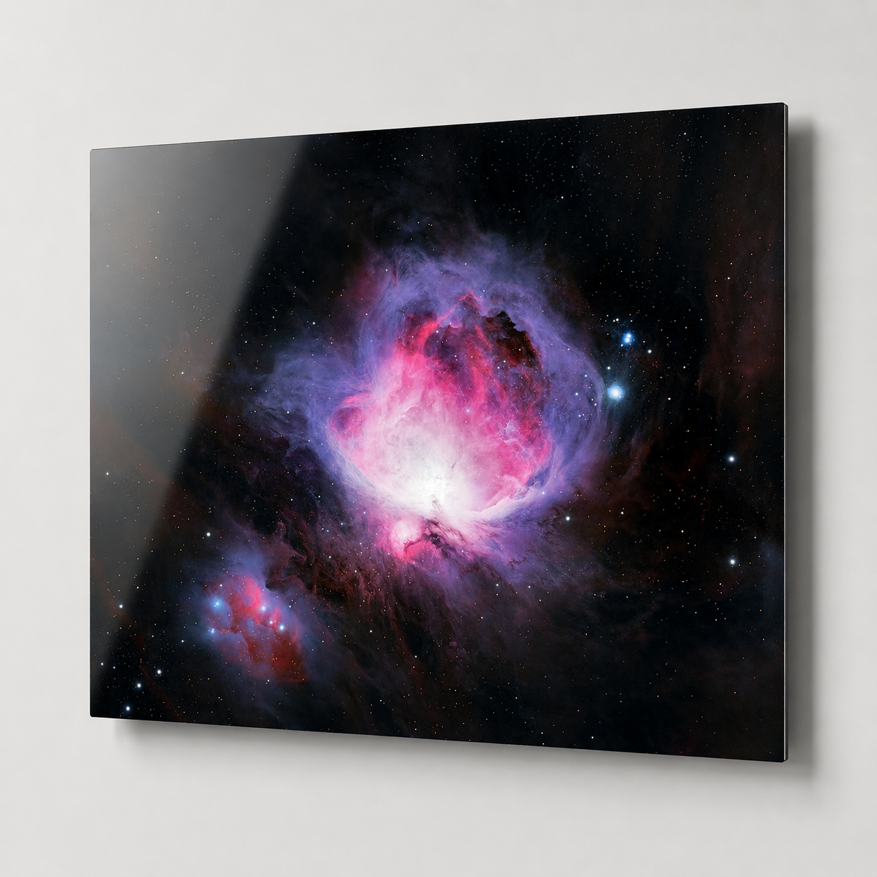 Stunning Orion Nebula glass wall art print featuring vibrant pink and purple cosmic clouds against a dark starry sky.