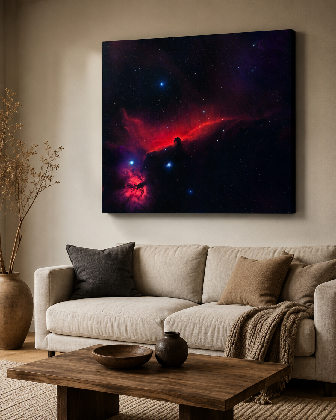 Dramatic nebula canvas wall art with red and black cosmic clouds displayed above a modern beige sofa in a cozy living room.