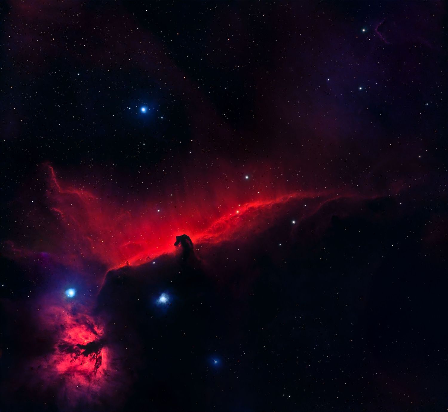 Horsehead Nebula glowing red in deep space with bright blue stars against a dark cosmic background.