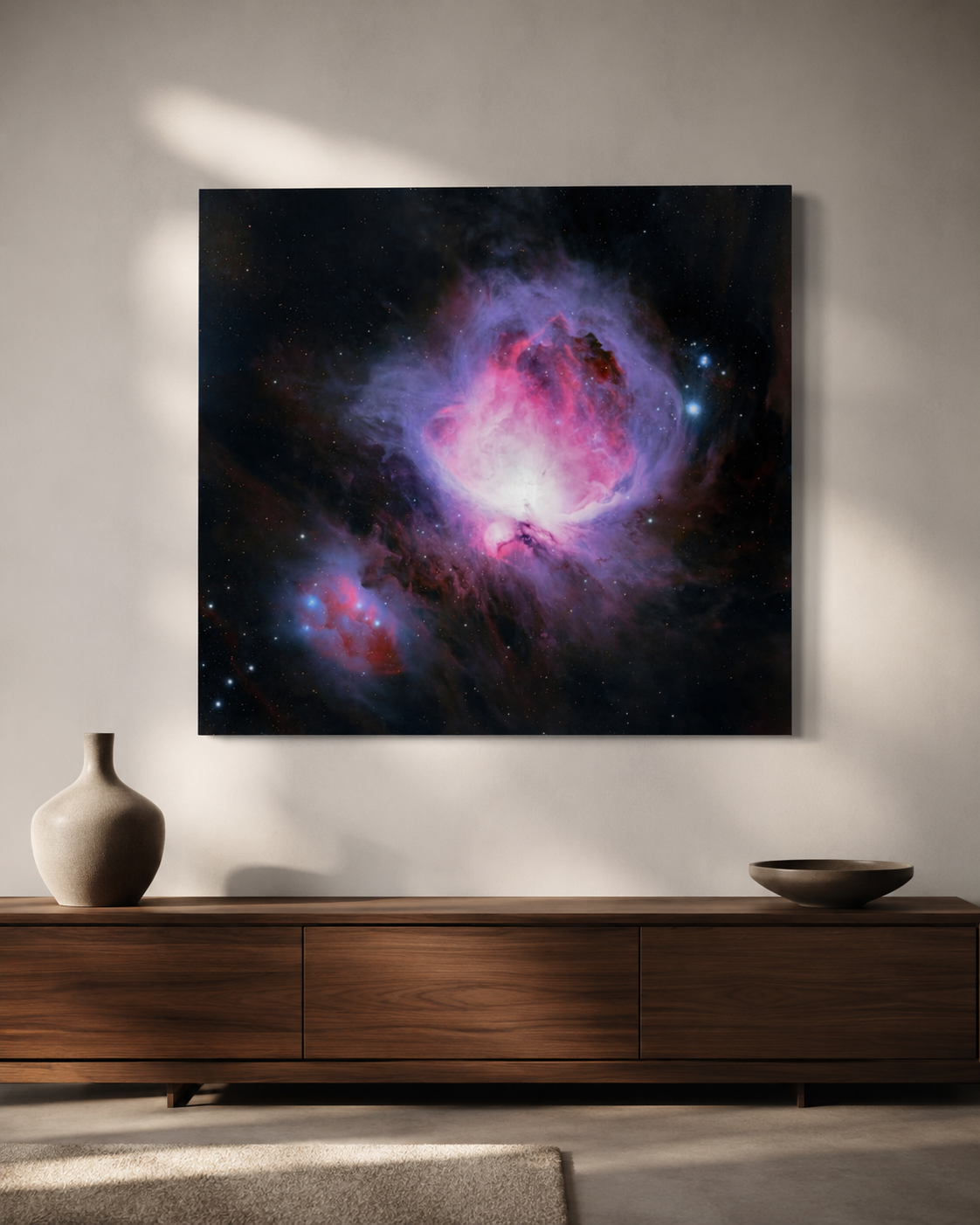 Canvas wall art of the Orion Nebula with vivid pink and purple hues, displayed above a wooden sideboard.